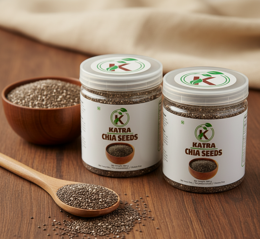 Two jars of Katra Chia Seeds on a wooden surface with a bowl and spoon.